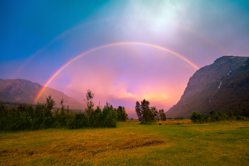 Beautiful rainbow over the mountains during sunset. Wilderness Norway © vvvita
