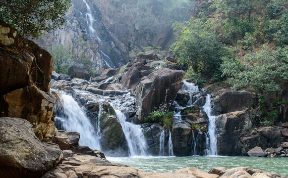 Lodh waterfall with sun rays in Jharkhand,India. Lens flare and light leak.