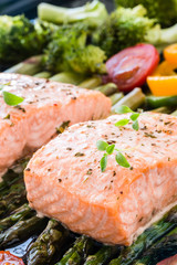 Baked salmon and vegetables on baking tray
