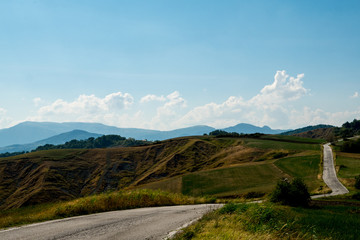 Fototapeta na wymiar Winding blacktop road through the hills, Monte Altavelio, Italy