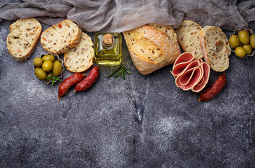 Italian ciabatta bread with olives and salami.