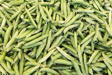 Green peas at market, background