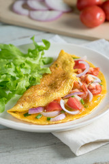 Omelet with shallot and cherry tomato.