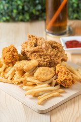 Fried chicken with nugget and french fries.