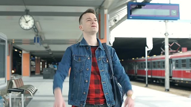 Man running for the train and looks irritated because he missed it, steadycam shot
