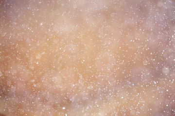 Fototapeta premium Snowfall texture of snowflakes on blurred background
