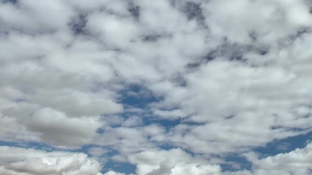 Beautiful clouds in the blue sky on a spring day in the sunlight. Time lapse 3840×2160