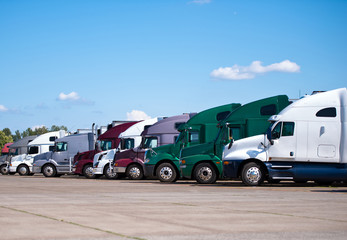 Semi trucks lined up on truck stop classic and modern