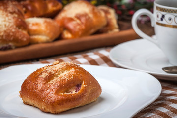 Buns with berries on a wooden table.
