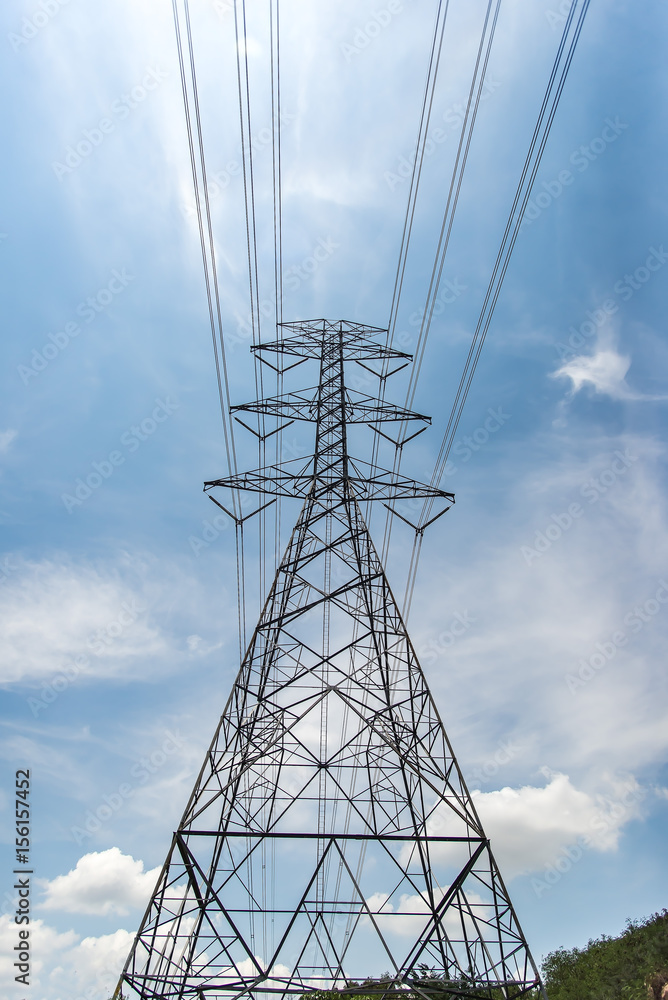 Wall mural high voltage transmission towers, background sky blue - green grass thailand