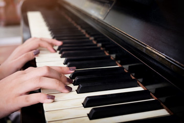 Close-up of a music performer's hand playing the piano