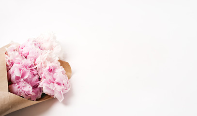 fresh pink flowers with paper on table
