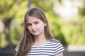 Cute blonde girl posing outdoor on a beautiful spring day