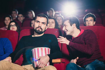 The guy in the cinema watching a movie interferes with conversation