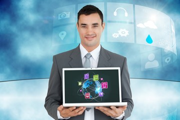 Businessman holding a laptop with graphics
