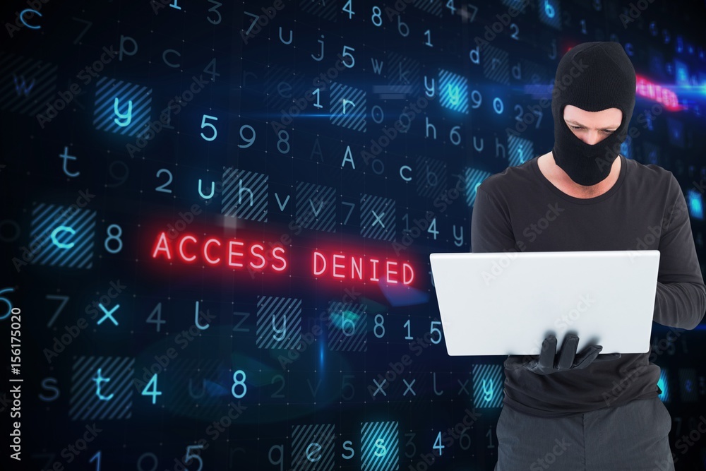 Poster hacker using a laptop with a dark screen background