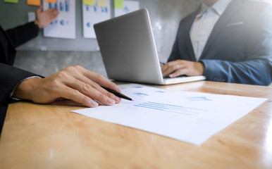 two business executives analyzing data paper at meeting room