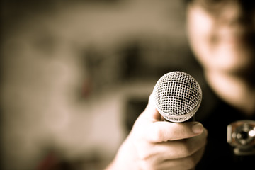 blurred of smart businessman speech, talking with microphone, gray scale tone