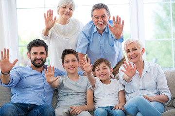 Happy family waving hands
