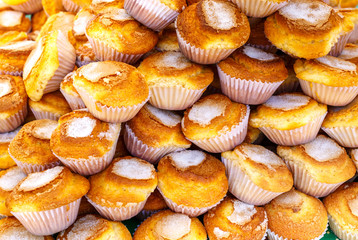 Pile of delicious baked muffins background.