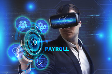 Business, Technology, Internet and network concept. Young businessman working in virtual reality glasses sees the inscription: Payroll