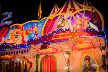 Illuminated colorful night moon with light rides and signs