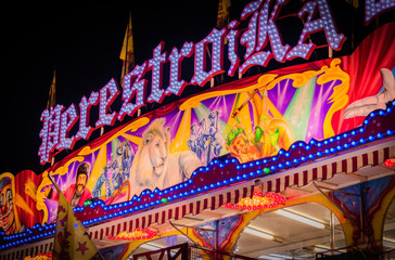 Illuminated colorful night moon with light rides and signs