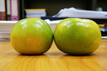 Two oranges on office table