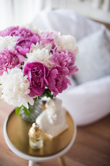 home decoration, fresh pink peonies on coffee table in white roo