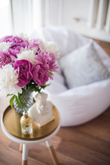 home decoration, fresh pink peonies on coffee table in white roo