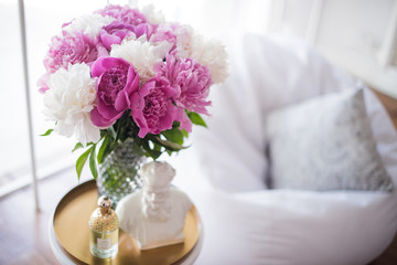 home decoration, fresh pink peonies on coffee table in white roo
