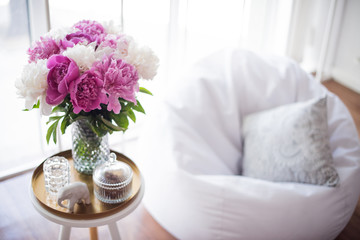 home decoration, fresh pink peonies on coffee table in white roo