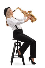 Woman sitting on a chair and playing a saxophone