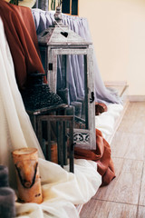 Lanterns with black candles stand beneath a dinner table
