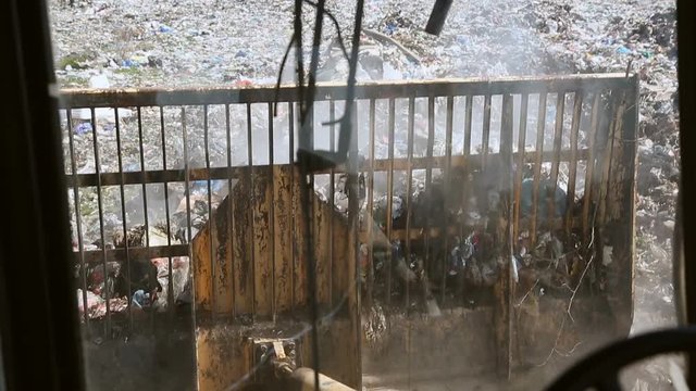 Bulldozer move trash in a landfill. Contamination of the environment. environmental disasters