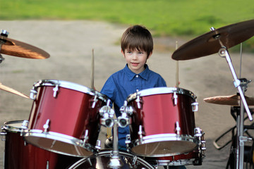 Boy learning to drum at the open air festival