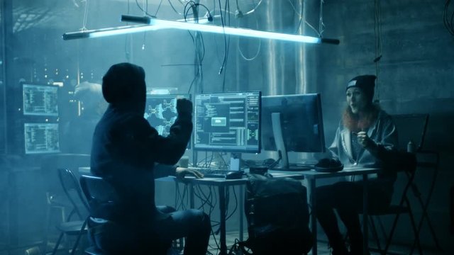 Group of Teenage Hackers Have Successful Attack on Government Servers. Their Den Has Monitors, Dark Atmosphere.Shot on RED EPIC-W 8K Helium Cinema Camera.