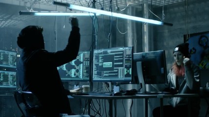 Group of Teenage Hackers Have Successful Attack on Government Servers. Their Den Has Monitors, Dark Atmosphere. Shot on RED EPIC-W 8K Helium Cinema Camera.