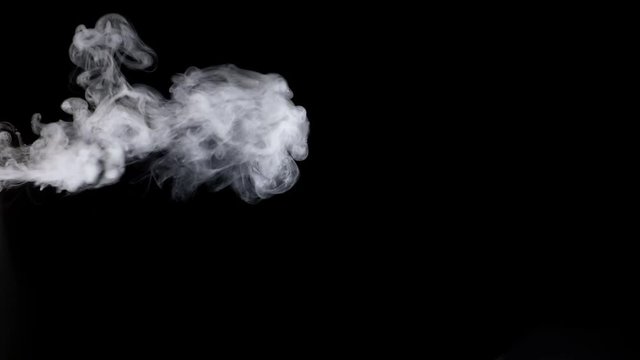 Smoke steam on black background in slow motion.
