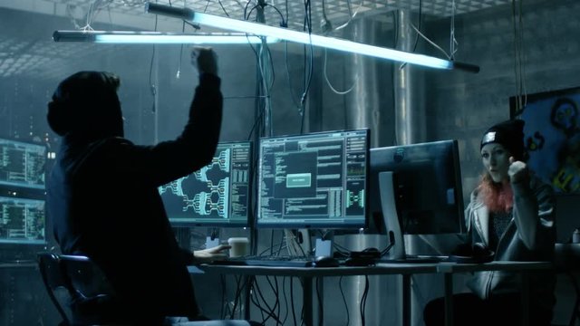Group of Teenage Hackers Have Successful Attack on Government Servers. Their Den Has Monitors, Dark Atmosphere. Shot on RED EPIC-W 8K Helium Cinema Camera.