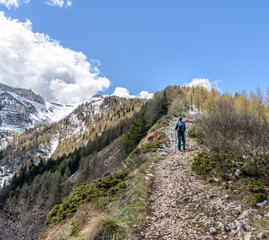 Fototapeta na wymiar A man with a backpack walk uphill the mountain trail .Hiking health sport lifestyle.