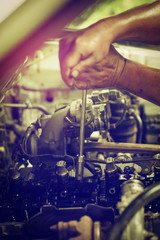 The hand is repairing the piston engine.