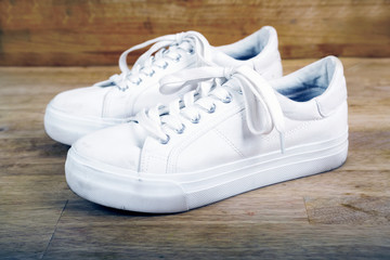 Pair of white sneakers with laces