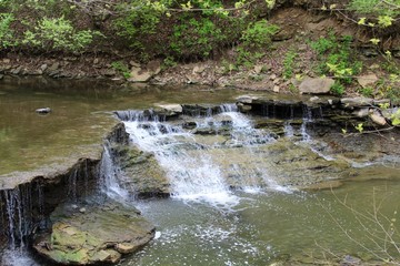 Naklejka na ściany i meble The waterfall ate the end of the creek. 