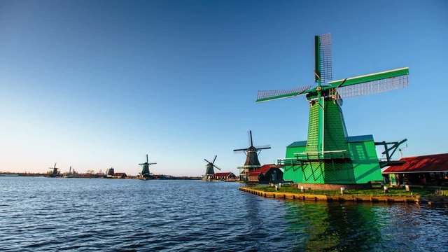 Green windmills in riverside of Rotterdam channel .Ecological engineering . Environmentally friendly solutions. Beauty of Holland.