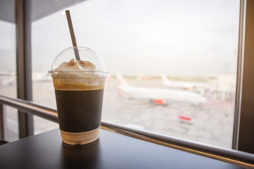 Cup of ice coffee. travelling relax time waiting for the journey coming. - obrazy, fototapety, plakaty