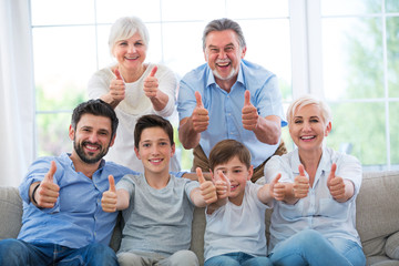 Family showing thumbs up
