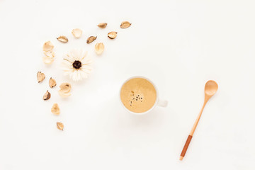 Composition with cup of coffee and flowers on white background. Top view, flat lay
