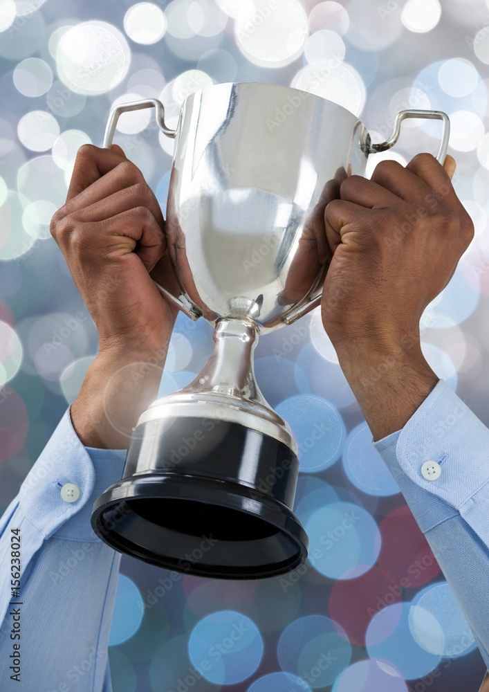 Poster hands holding trophy cup with sparkling light bokeh background