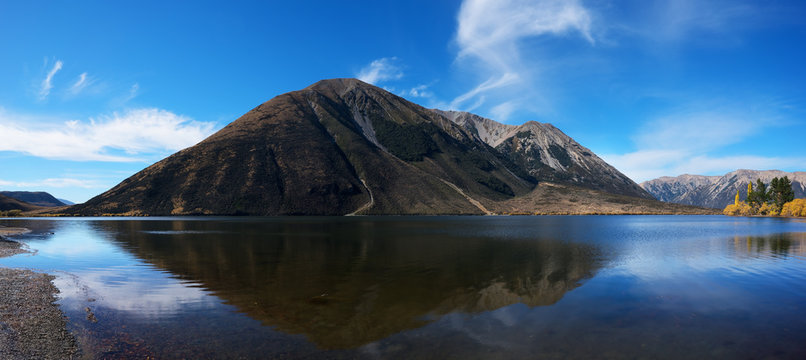 Panoramic image of beautiful scenery of Lake Pearson (Moana Rua) in Autumn with reflection ,  Arthur's pass National Park , South Island of New Zealand